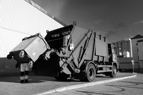 Council waste collection team handling bulky rubbish in a London residential street