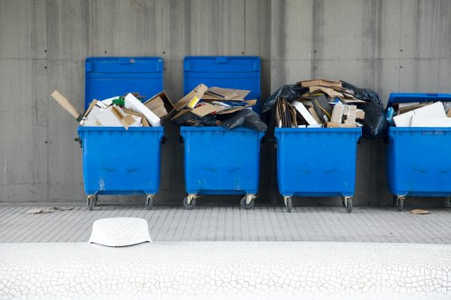 Local rubbish collection team handling household waste in a London street