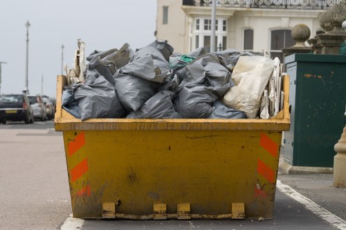 Rubbish removal team collecting waste from a property